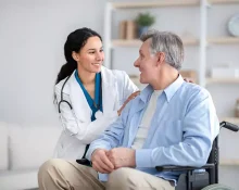 Doctor and senior patient both smiling warmly at each other