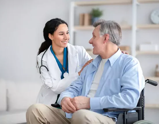 Doctor and senior patient both smiling warmly at each other