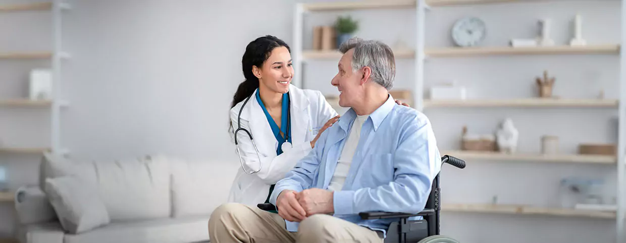 Doctor and senior patient both smiling warmly at each other