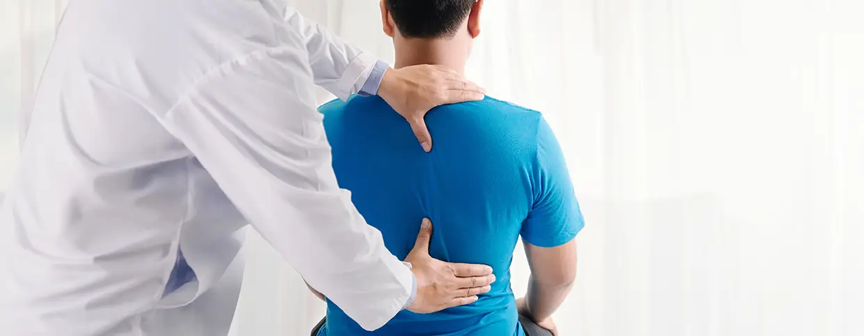 Physiotherapist treating patient's upper back