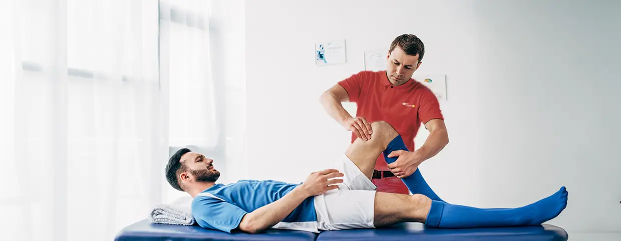 Physiotherapist treating a young man