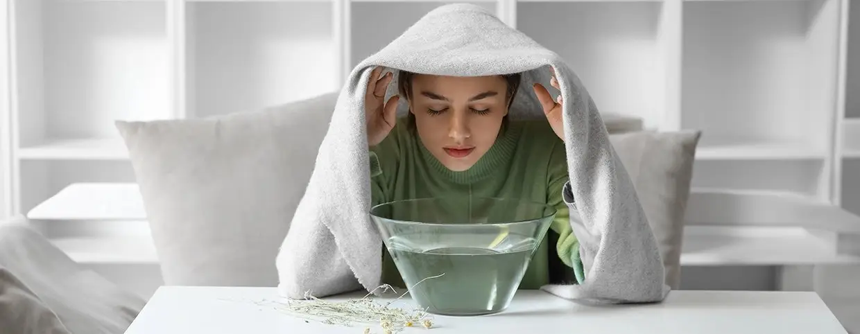 Young girl taking steam to get rid of flu