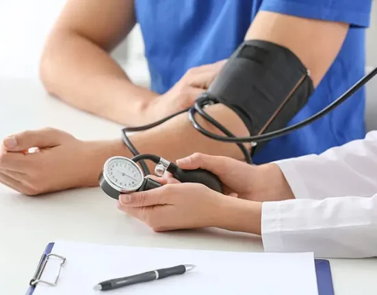 Doctor checking the blood pressure of a patient